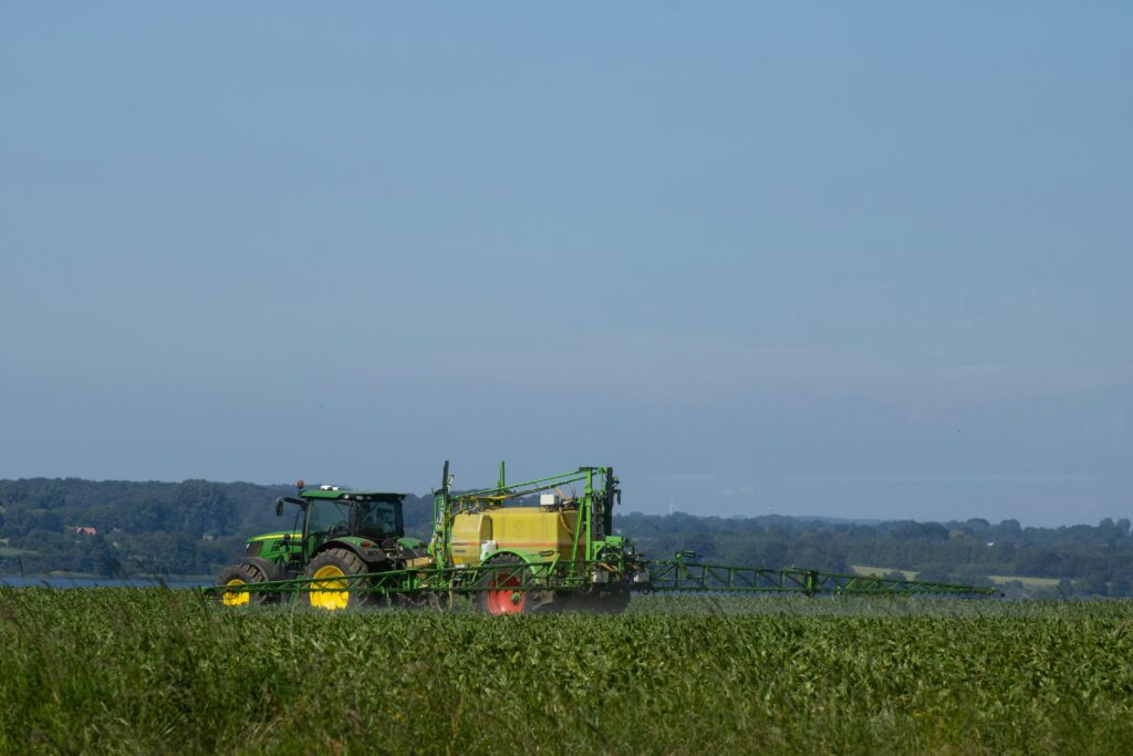John Deere tractor on a field spraying