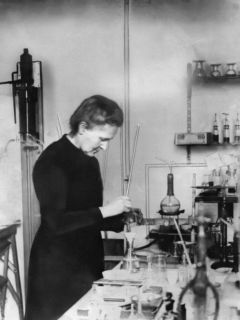 Marie Curie working at a lab bench