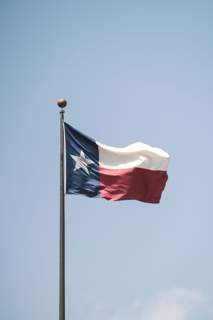 Texas flag flying in the wind