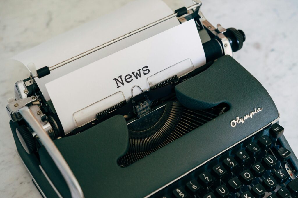 A typewriter with "News" printed on the page