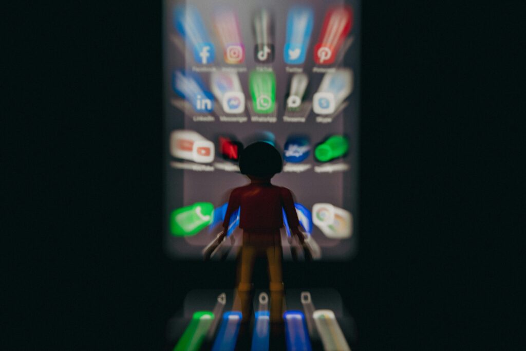 A model of a child in front of a large cell phone