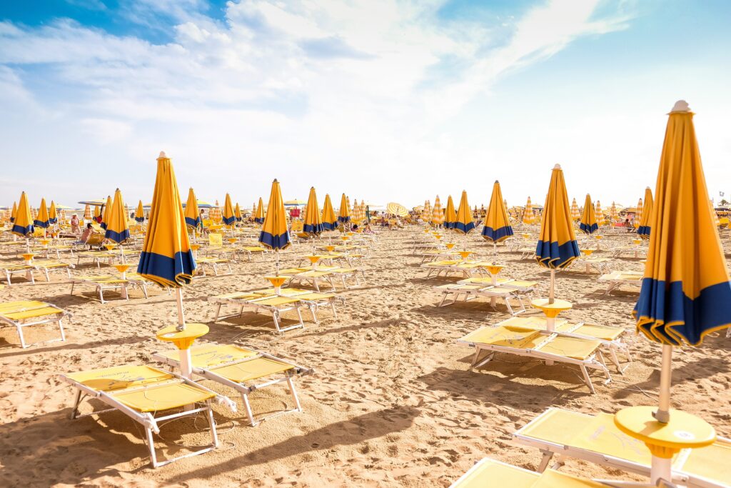 A beach with chairs and umbrellas