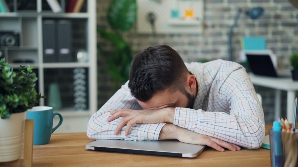 a man sleeping at his desk
